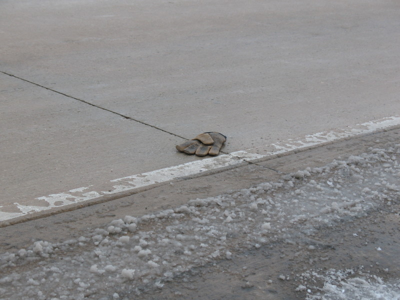 gloves in road with slush in watertown